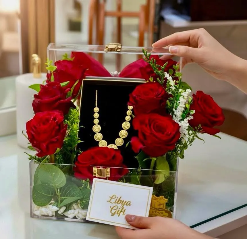 Acrylic rose box with a gold necklace
